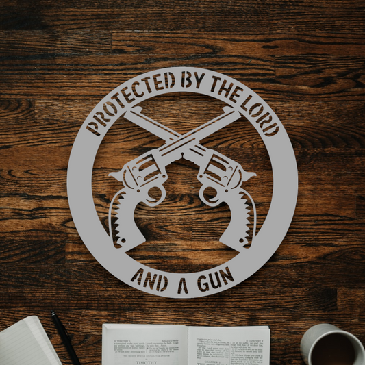 protected by the lord and a gun metal sign